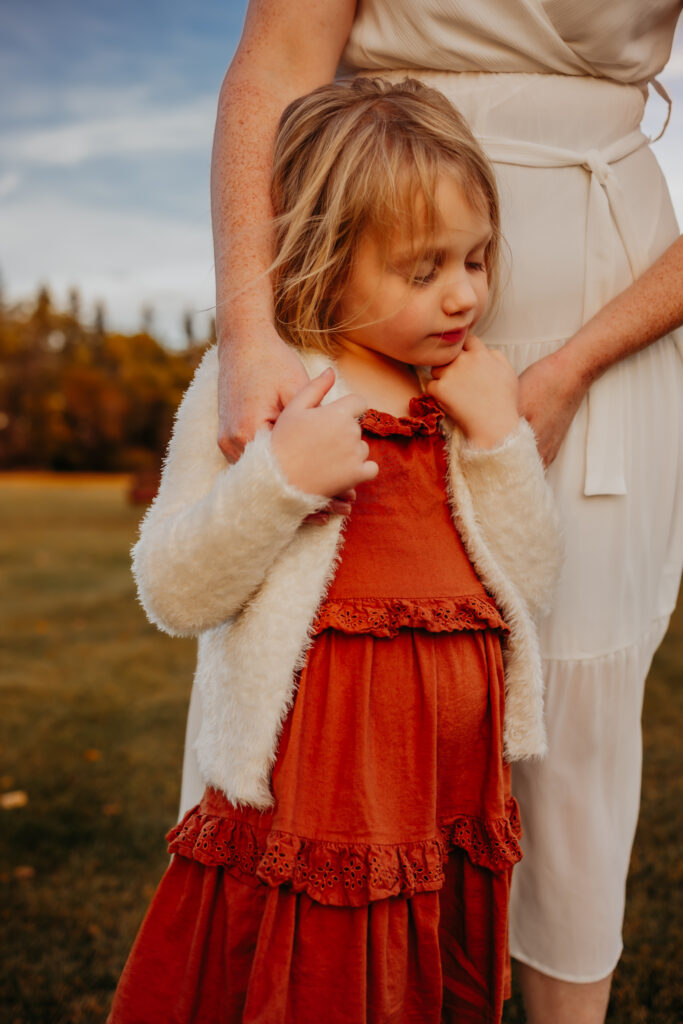 a mom hugs her daughter during a family photo shoot in Edmonton