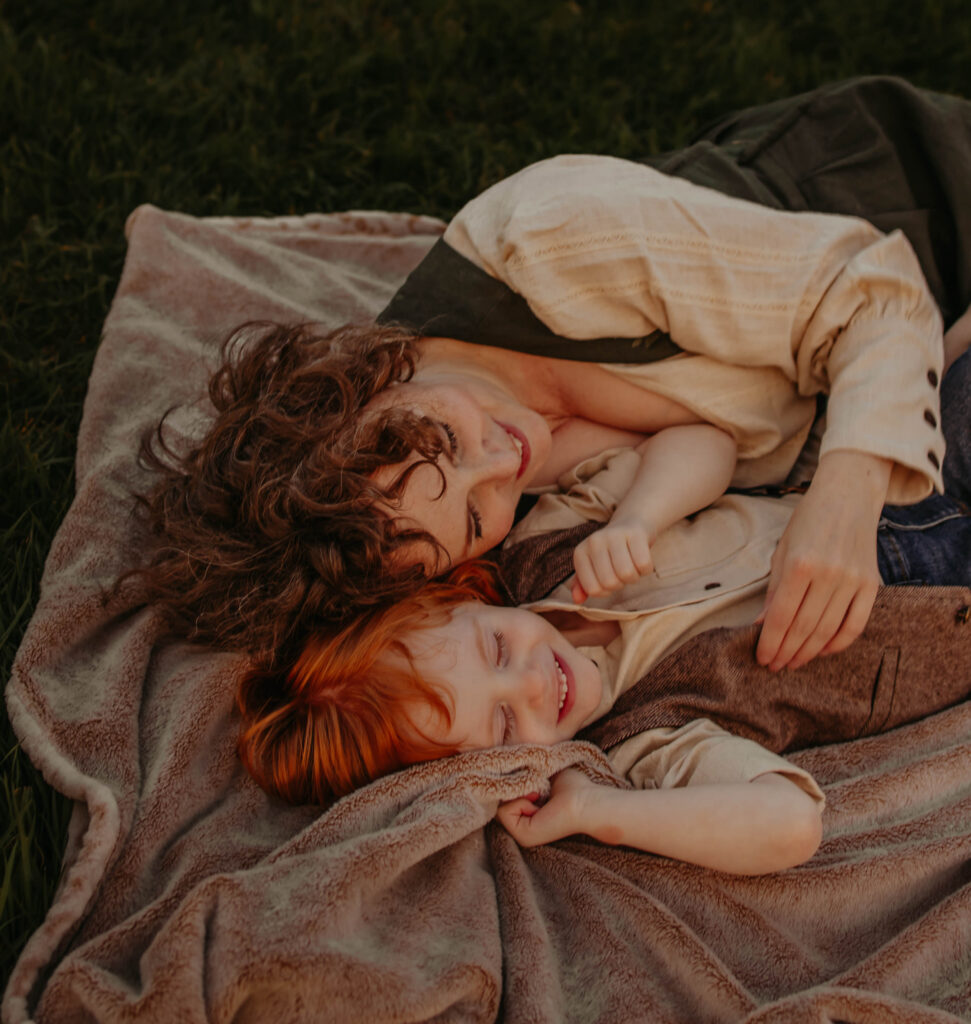 mom and son cuddle during fall family photo session in Edmonton