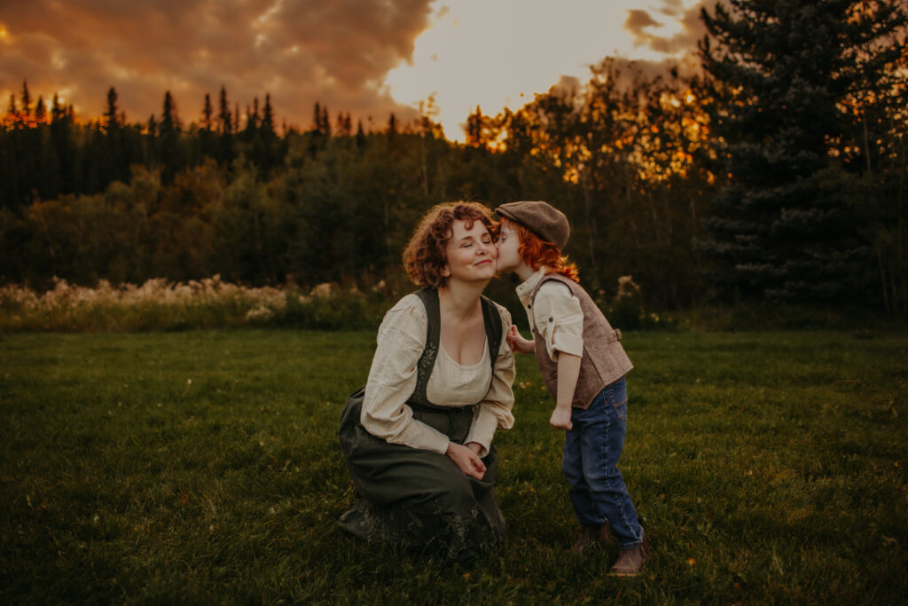 mom and son cuddle during fall family photo session in Edmonton