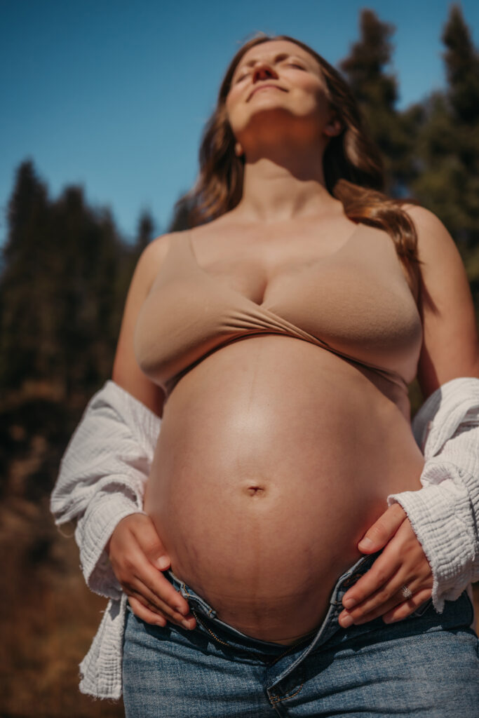 pregnant woman stands outside for her Edmonton maternity photos