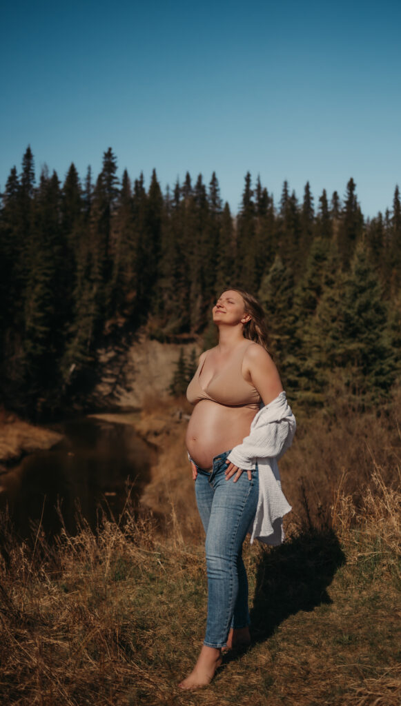 pregnant woman stands outside for her Edmonton maternity photos