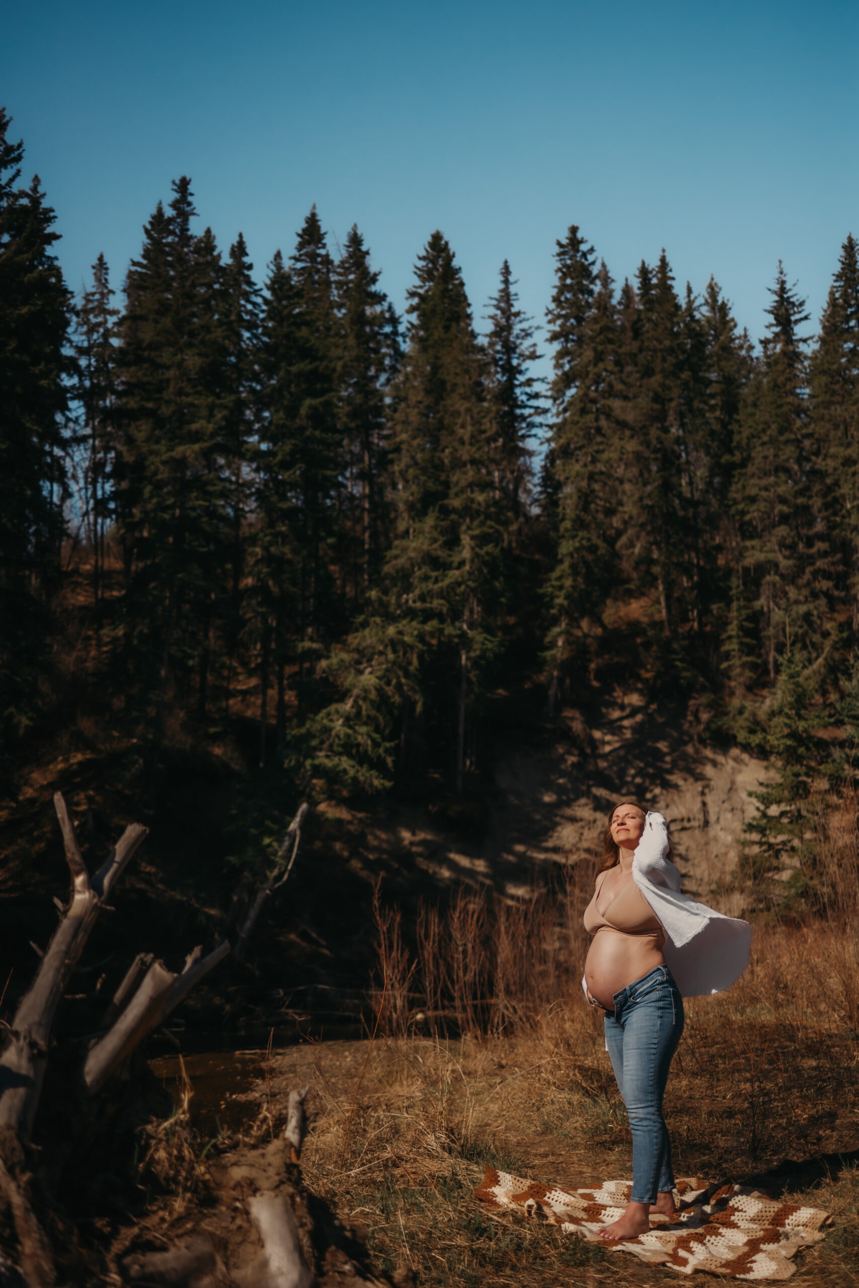 pregnant woman stands outside for her Edmonton maternity photos