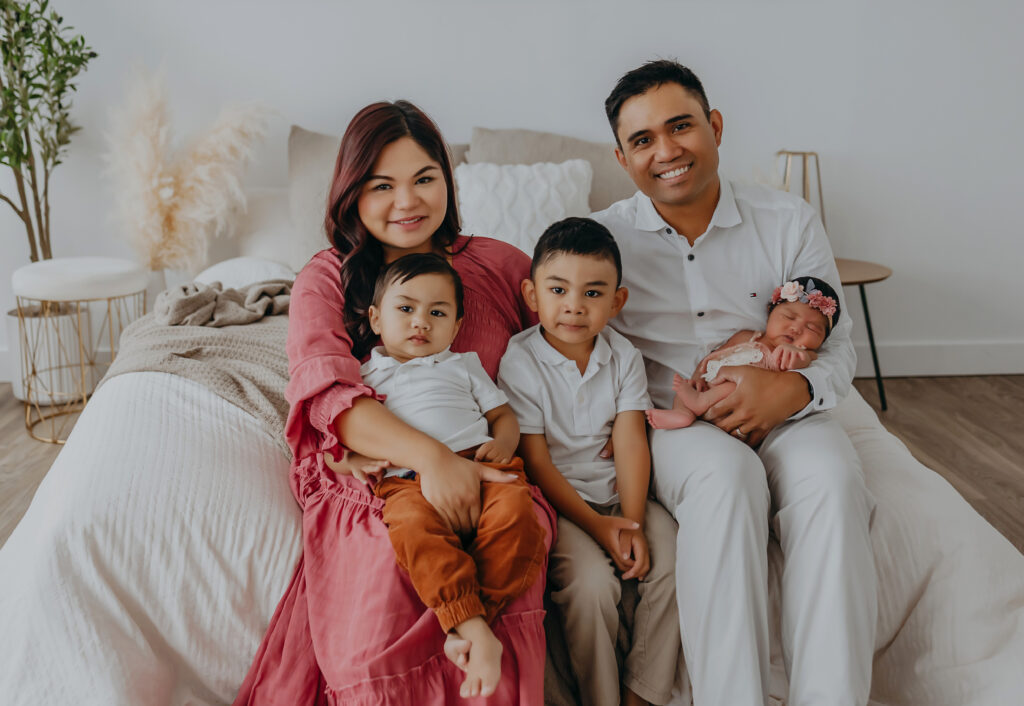 family poses for newborn photos edmonton