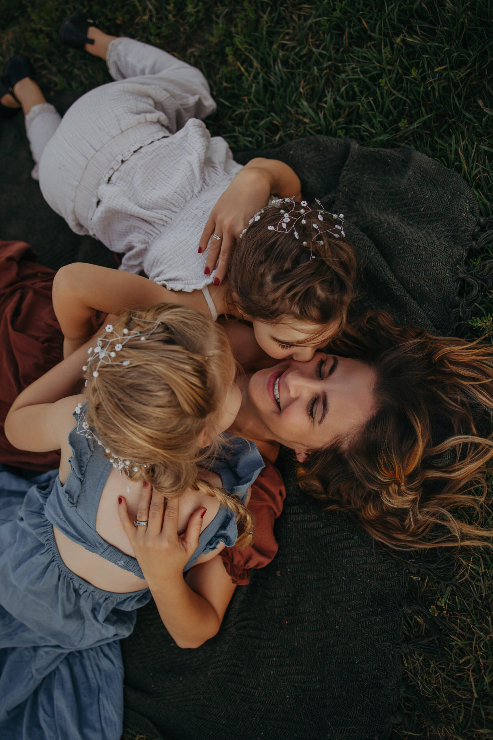 mom and children lay in the grass during edmonton fall family photos