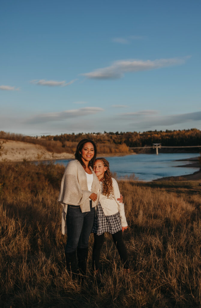mom and daughter pose for fall edmonton family photos in the river valley