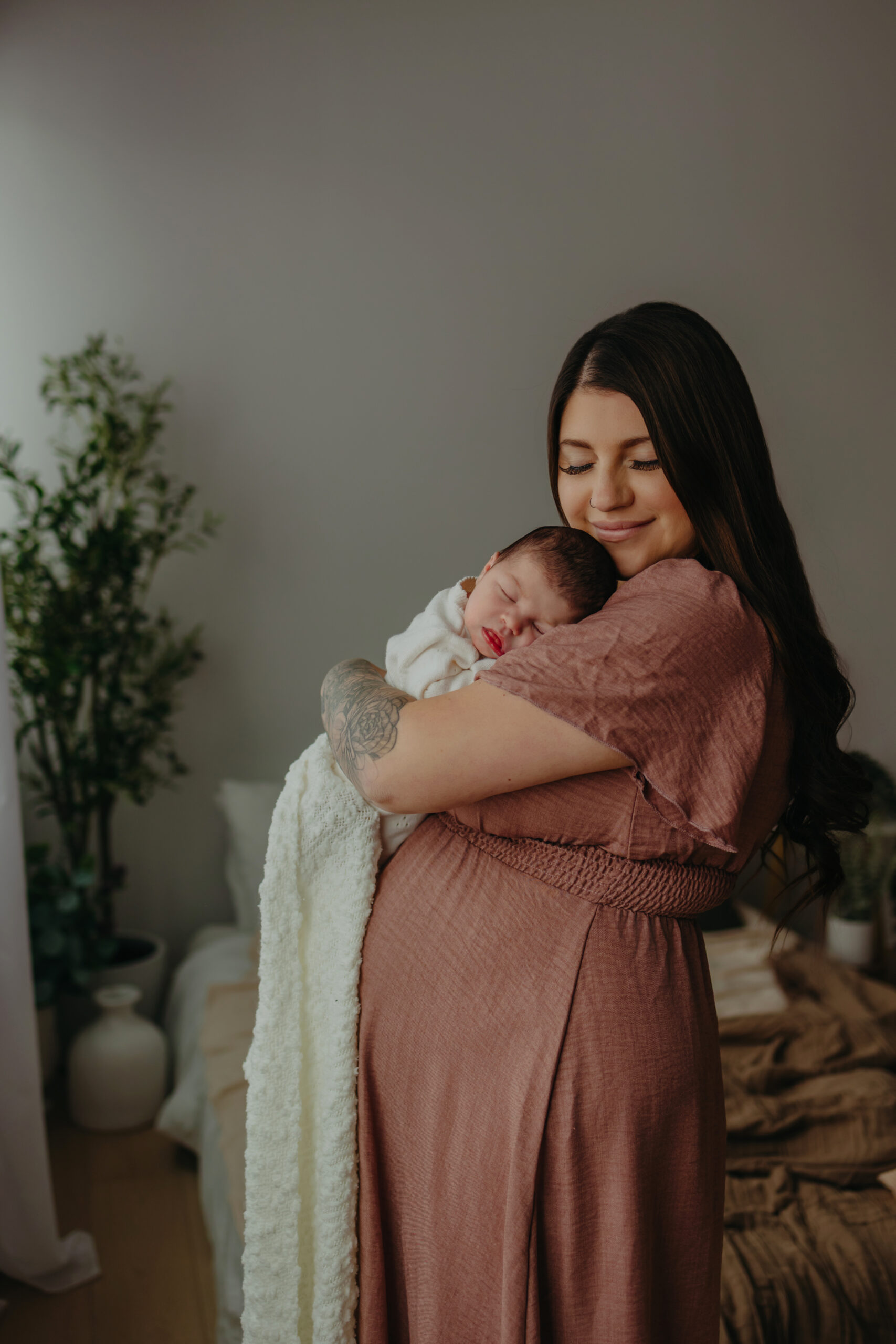 Newborn photographer in Edmonton capturing mother and newborn in studio