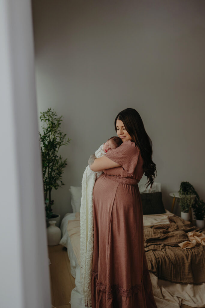 Newborn photographer in Edmonton capturing mother and newborn in studio