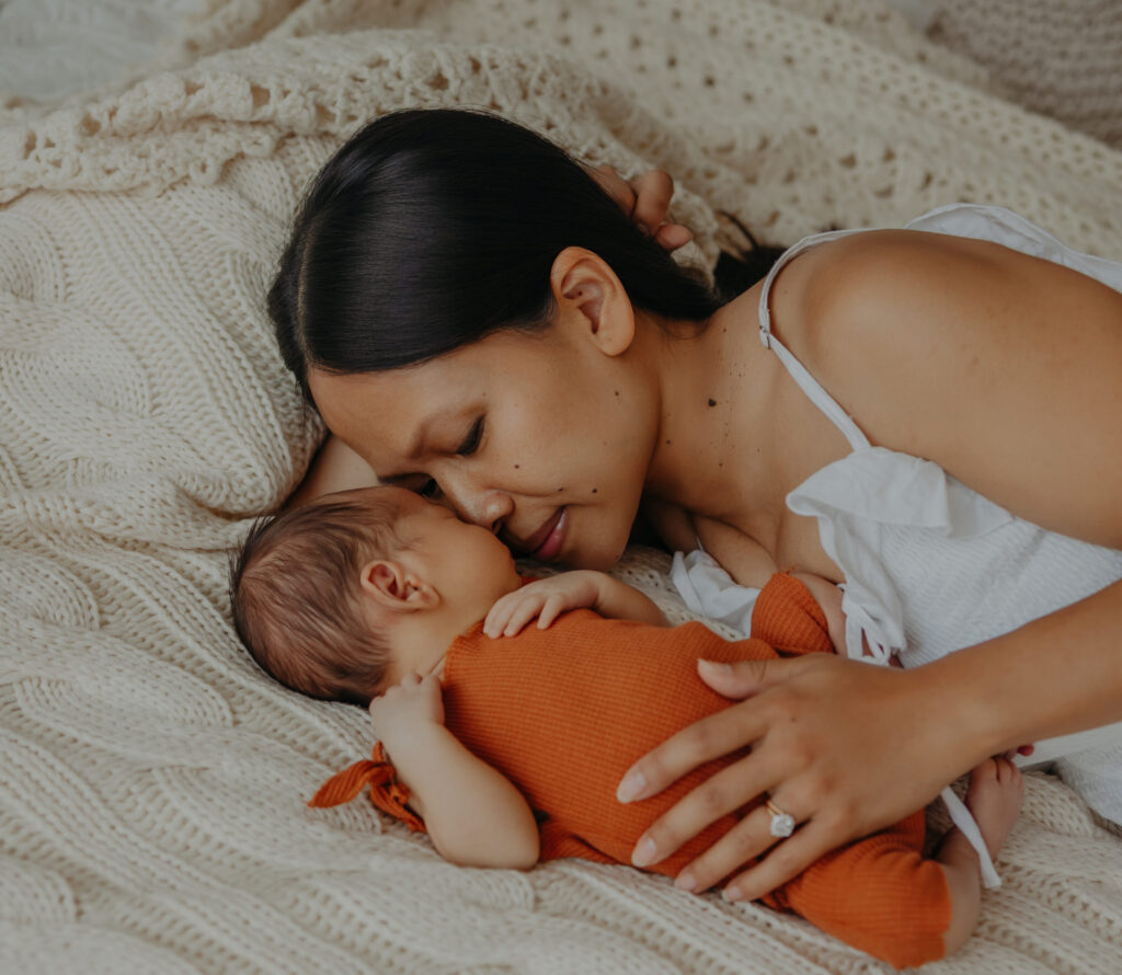 mom and baby lie down during newborn photos in edmonton