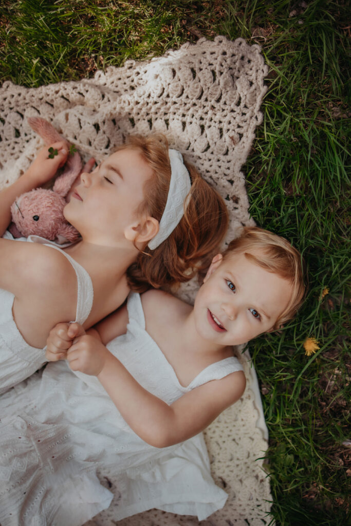 kids wearing neutral outfits during cherry blossom photos in Edmonton